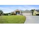 Charming single-story home with a well-manicured lawn, two-car garage, and a welcoming front porch at 5524 Loma Vista, Davenport, FL 33896