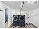 Laundry room with modern, matching washer and dryer on wood-look flooring at 5524 Loma Vista, Davenport, FL 33896