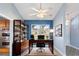 Cozy home office with large window, built in bookshelves, dark desk and ceiling fan at 5524 Loma Vista, Davenport, FL 33896