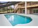 Inviting private swimming pool with a screened enclosure and attached deck at 5524 Loma Vista, Davenport, FL 33896