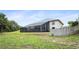 Exterior view of home featuring a screened in porch and spacious yard at 5524 Loma Vista, Davenport, FL 33896
