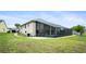 Wide exterior view of home showcasing a screened in porch with staircase and yard at 5524 Loma Vista, Davenport, FL 33896