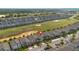 A high aerial view shows the golf course community featuring many homes and landscaping at 581 Pebble Beach Dr, Davenport, FL 33896