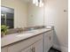 Bathroom featuring a double sink vanity with modern fixtures and a large mirror at 581 Pebble Beach Dr, Davenport, FL 33896