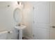This powder room features a pedestal sink and modern fixtures at 581 Pebble Beach Dr, Davenport, FL 33896