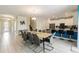 Open concept dining room, featuring a large table and chairs, with access to the kitchen at 581 Pebble Beach Dr, Davenport, FL 33896