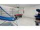 This large garage features a ping pong table, air hockey table, and arcade games at 581 Pebble Beach Dr, Davenport, FL 33896