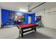 This finished garage features a ping pong table, arcade games, and a Star Wars poster at 581 Pebble Beach Dr, Davenport, FL 33896