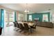 Open-concept living and dining area with a view of the pool through sliding glass doors and stylish decor at 581 Pebble Beach Dr, Davenport, FL 33896