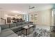 Spacious living room with an open floor plan, tile flooring, and a comfortable sectional sofa at 581 Pebble Beach Dr, Davenport, FL 33896