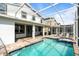 This beautiful pool with a jacuzzi and a screened-in enclosure has a covered patio at 581 Pebble Beach Dr, Davenport, FL 33896