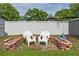 An outdoor relaxation area with white chairs, and a small brick garden at 7629 Marietta St, Orlando, FL 32807