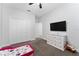 Bright bedroom with plush carpeting, a ceiling fan, and a dresser with a mounted television at 7629 Marietta St, Orlando, FL 32807