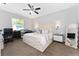 Comfortable bedroom featuring a ceiling fan, carpet floors, a window, and a decorative headboard at 7629 Marietta St, Orlando, FL 32807