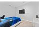 Neutral bedroom featuring sleek furniture, carpeted floors, and a mounted TV at 7629 Marietta St, Orlando, FL 32807