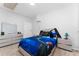 A cute bedroom featuring a bed with blue-themed bedding, complemented by matching furniture, and a cozy ambiance at 7629 Marietta St, Orlando, FL 32807