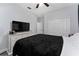 Comfortable bedroom with a dresser, mounted television, and spacious closet at 7629 Marietta St, Orlando, FL 32807