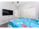 Bright bedroom with plush carpeting, a ceiling fan and a large closet at 7629 Marietta St, Orlando, FL 32807