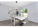 Elegant dining room with a modern table, stylish chairs, and a chic light fixture, bathed in natural light at 7629 Marietta St, Orlando, FL 32807