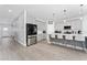 Bright, open kitchen with stainless steel appliances, white countertops, and barstool seating at the island at 7629 Marietta St, Orlando, FL 32807