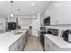 Spacious kitchen featuring stainless steel appliances, a kitchen island, and modern light fixtures at 7629 Marietta St, Orlando, FL 32807