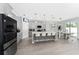 Well-designed kitchen with a kitchen island, barstool seating, stainless appliances, and sleek finishes at 7629 Marietta St, Orlando, FL 32807