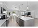 Open-concept kitchen with an island and views of the dining and living areas at 7629 Marietta St, Orlando, FL 32807
