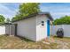 Backyard shed with blue door and storage at 7629 Marietta St, Orlando, FL 32807