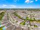 Expansive aerial view of a residential neighborhood showcasing well-maintained homes and landscaping under a bright blue sky at 7665 Fairfax Dr, Kissimmee, FL 34747