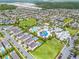 A captivating aerial view showcasing the community pool and recreational area, surrounded by lush landscaping and homes at 7665 Fairfax Dr, Kissimmee, FL 34747