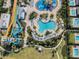 Aerial view of water park with water slides, pools, lounge chairs, and manicured landscaping at 7665 Fairfax Dr, Kissimmee, FL 34747