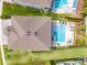 An aerial view of the house with a large pool, jacuzzi, patio, and lounge chairs at 7665 Fairfax Dr, Kissimmee, FL 34747