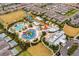 Aerial view of a community featuring a water park, pools, single-Gathering homes, and green spaces at 7665 Fairfax Dr, Kissimmee, FL 34747