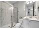 Bright bathroom featuring a shower with marble tile and glass door, and a white sink vanity at 7665 Fairfax Dr, Kissimmee, FL 34747