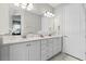 Bathroom with double sinks, a large mirror, and ample cabinet space at 7665 Fairfax Dr, Kissimmee, FL 34747