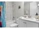 Cozy bathroom with a shower and tub combo and a stylish vanity with a marble countertop at 7665 Fairfax Dr, Kissimmee, FL 34747