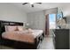 A primary bedroom featuring a queen bed, soft lighting, and decorative art at 7665 Fairfax Dr, Kissimmee, FL 34747