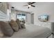 Bedroom featuring white bed, dresser with TV, and balcony access at 7665 Fairfax Dr, Kissimmee, FL 34747