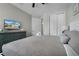 Bedroom featuring a queen bed, ceiling fan, TV, and closet at 7665 Fairfax Dr, Kissimmee, FL 34747