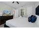 Bedroom featuring a luxe, plush blue headboard and television at 7665 Fairfax Dr, Kissimmee, FL 34747