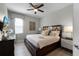 Bedroom featuring a dark wood bed frame, wood flooring, and a ceiling fan at 7665 Fairfax Dr, Kissimmee, FL 34747