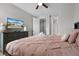 Comfortable bedroom featuring a ceiling fan and a dresser with a TV for added entertainment at 7665 Fairfax Dr, Kissimmee, FL 34747