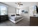 Bedroom featuring a queen bed, ceiling fan, ensuite bathroom, and closet at 7665 Fairfax Dr, Kissimmee, FL 34747