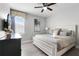 Bright bedroom features a comfortable bed, modern furnishings, and ample natural light at 7665 Fairfax Dr, Kissimmee, FL 34747