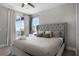 Bedroom featuring gray bed, balcony access, and accent pillows offering a relaxing retreat at 7665 Fairfax Dr, Kissimmee, FL 34747