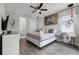 Well-lit bedroom with a gray bed, a stylish vanity, and an ensuite bathroom at 7665 Fairfax Dr, Kissimmee, FL 34747
