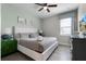 Comfortable bedroom featuring a queen bed, ceiling fan, and bright window at 7665 Fairfax Dr, Kissimmee, FL 34747