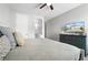 Comfortable bedroom features a ceiling fan and a dresser with a TV for added entertainment at 7665 Fairfax Dr, Kissimmee, FL 34747