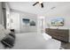 Bedroom featuring a queen bed, ceiling fan, TV, and ensuite bathroom at 7665 Fairfax Dr, Kissimmee, FL 34747