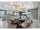 Elegant dining room featuring three decorative chandeliers and a view into the luxurious living room at 7665 Fairfax Dr, Kissimmee, FL 34747